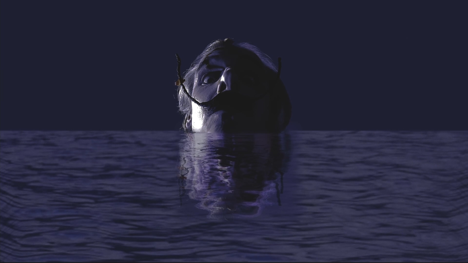 Still de Dalí Video-Espetáculo com artista circense em cena iluminada.